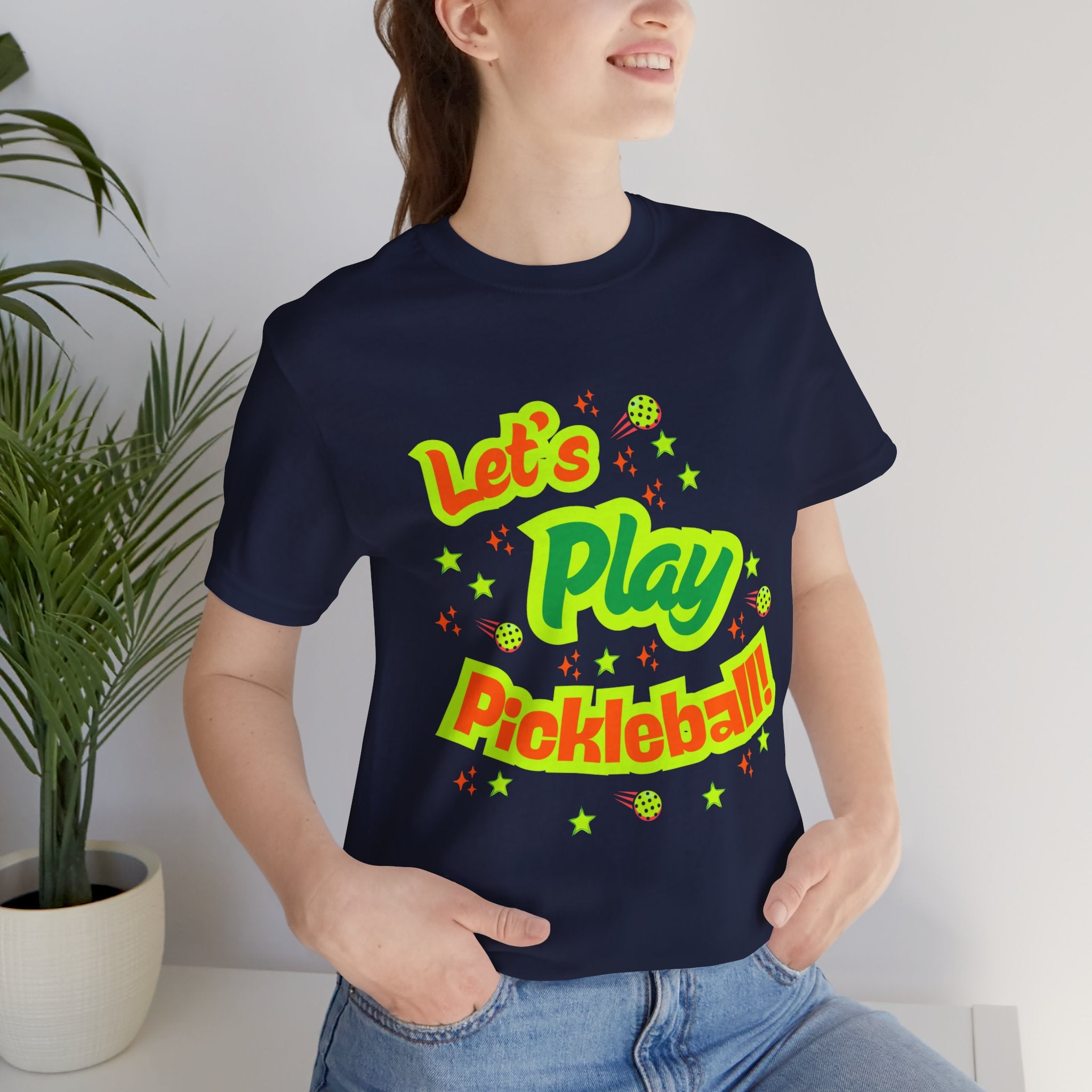 Neon orange and electric green pickleball rally tee with court graphic, casual Printify T-shirt for active sports fans.
