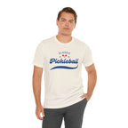 Red and blue pickleball script T-shirt with paddle and ball graphic, casual printify branded apparel for pickleball enthusiasts