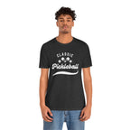 White pickleball T-shirt with "Pickleball" script design, lightweight cotton, casual fit, by Printify.