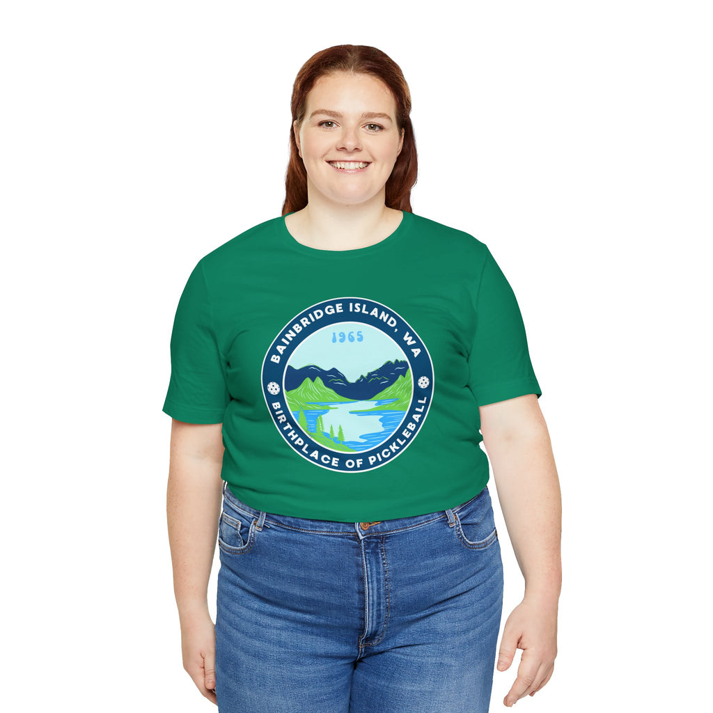 Unisex Bainbridge Island Pickleball T-Shirt with "Birthplace of Pickleball 1965" graphic, white fabric, casual style.