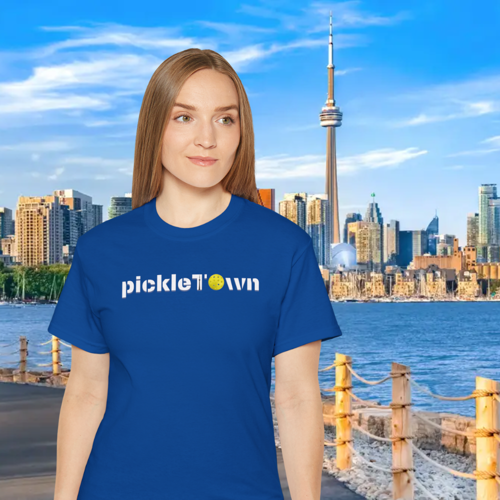 Toronto PickleTOwn T-Shirt by PeaMac Pickleball Tees featuring the CN Tower and pickleball design on a court background.