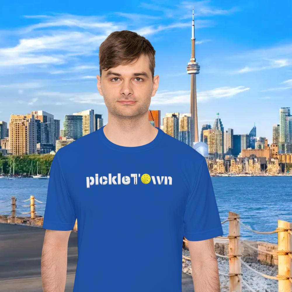 Toronto PickleTOwn T-Shirt by PeaMac Pickleball Tees featuring CN Tower and pickleball design on a court background.