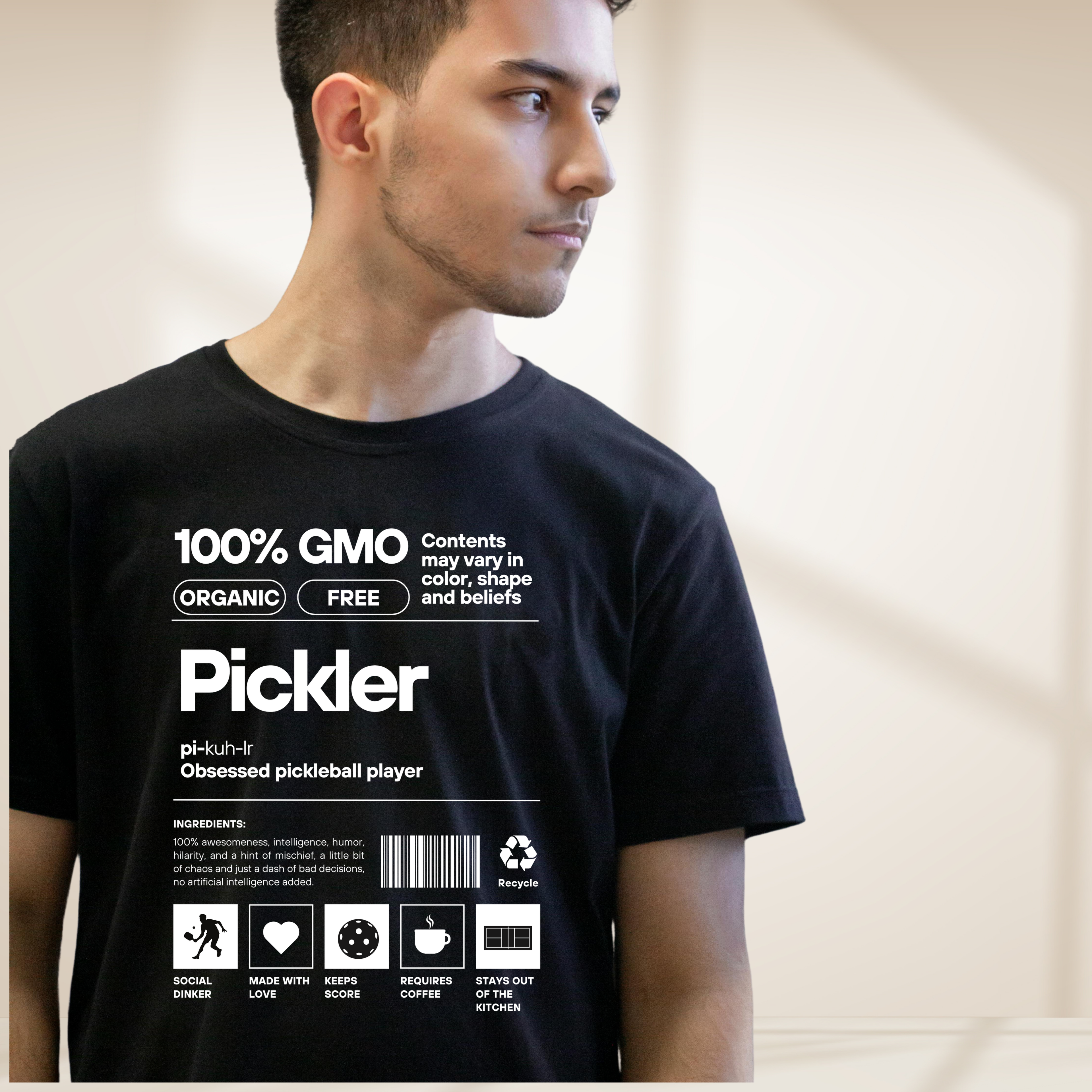 Close-up of white Pickler Funny Definitions T-Shirt by PeaMac Pickleball Tees, featuring humorous pickleball-themed text on a tri-blend fabric.