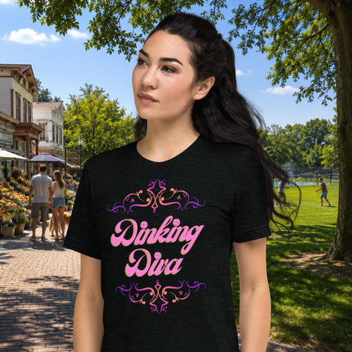 Pink Dinking Diva Pickleball T-Shirt by PeaMac Pickleball Tees featuring a stylish filigree design and athletic fit, shown against a park backdrop.