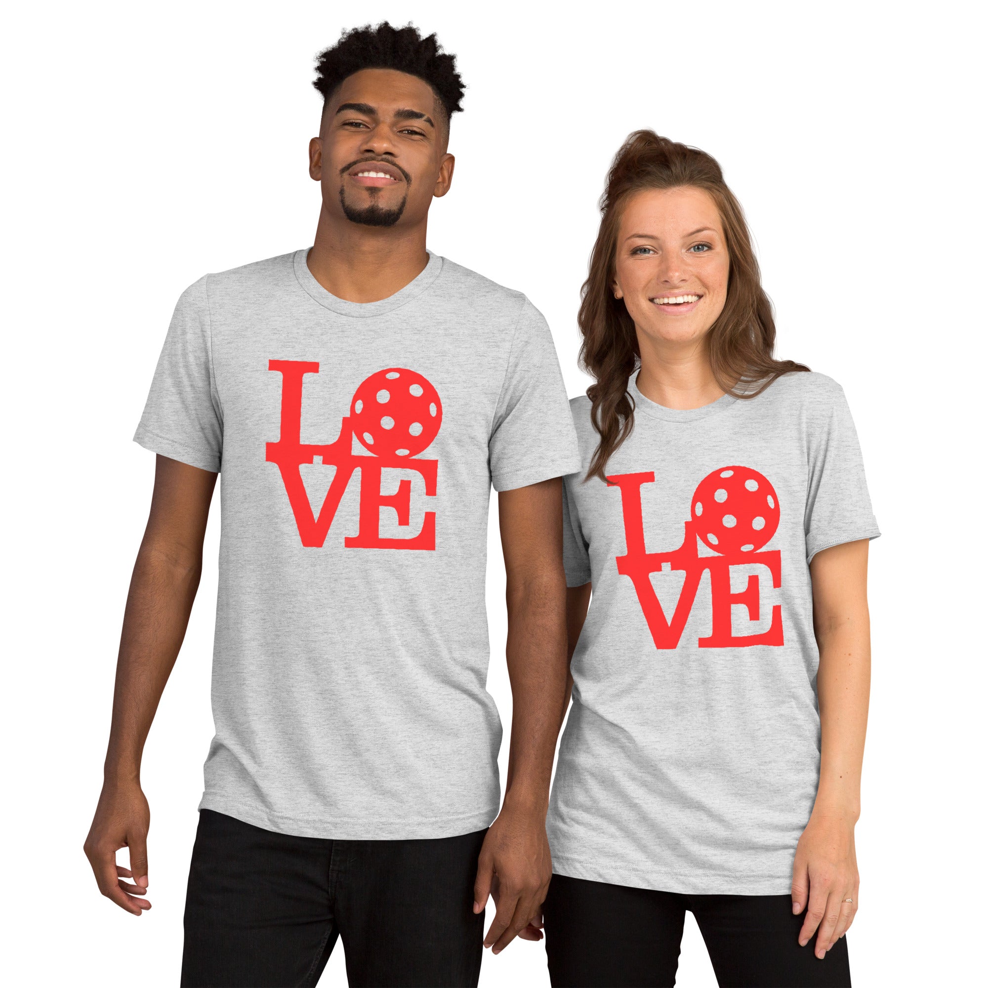 Unisex white tri-blend T-shirt with bold red love pickleball graphic print, featuring pop art design from PeaMac Pickleball Tees.