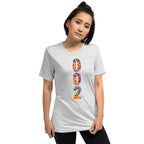 Unisex white tri-blend pickleball T-shirt with psychedelic design by PeaMac Pickleball Tees, front view showing vibrant print.