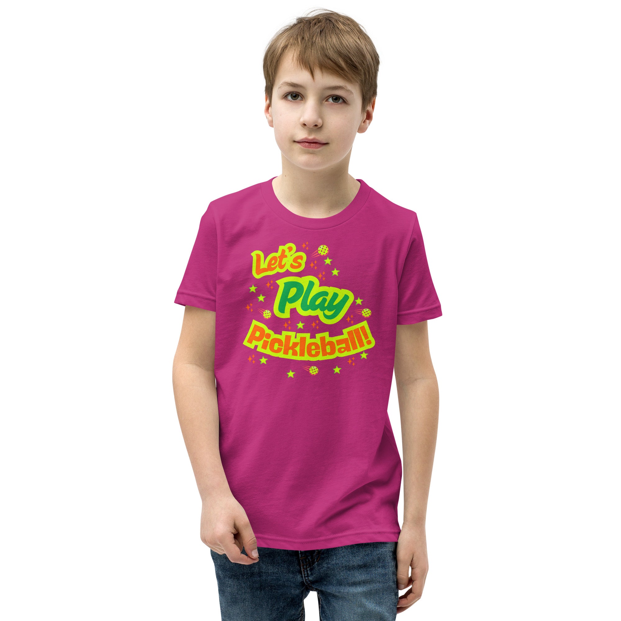 Bright pink youth T-shirt with neon pickleball graphic from PeaMac Pickleball Tees, perfect for kids who love pickleball.